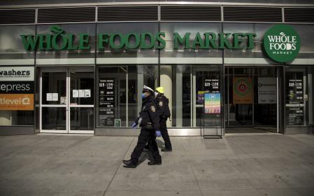 NEW YORK, NEW YORK - APRIL 14: Two New York City Police Department Traffic Enforcement agents walk past the Whole Foods Market on April 14, 2020 in the Brooklyn borough of New York City. (Photo by Justin Heiman/Getty Images)